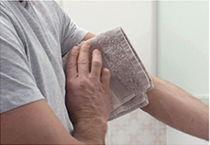 Person using a towel to clean and dry the affected skin